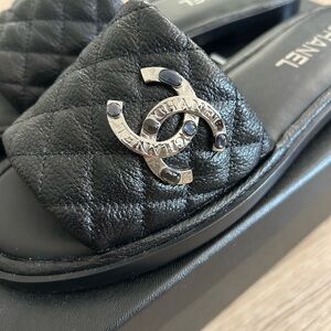 CHANEL Black 22A slides with silver CC